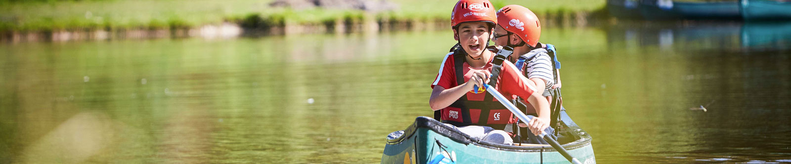 Two boys in a canoe on a lake